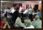 M.C. Bill Blickensderfer, Auctioneer Riley Waltman and V.P. Dennis Dunlap on stage during the auction at the 2009 Rapid City Banquet.