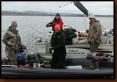 Tournament anglers (left and right in camo) bring fish in to be measured at the 2009 Black Hills Anglers Catch and Release tournament. SDWU volunteers Mike Johnson (orange stocking cap), Brenda Johnson (SDWU ballcap) and Nancy Smidt (red guidewear) worked the official's boat.