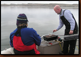 Not too cold for a hot lunch on the official's boat. Mike Johnson cooked burgers while Nancy Smidt supervised.