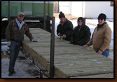 Denny Bohls, Ken Edel, Brenda Johnson and Dan Amen admire the new decking on the dock project.