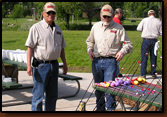 Ray Barck and Louie Schwengler hand out rods to the children.