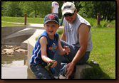 Zane gets a little help from Rick with his latest catch.
