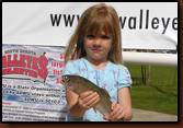 The fish is almost bigger than she is.