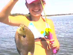 Aanna excitedly displays her first catch, a 10.25 inch bluegill, caught in one of the beautiful northeast SD glacial lakes in August 2008 with her 3 foot Barbie pole.  Her proud father, Blaze, and family are members of SD Walleyes Unlimted.