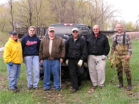 Nancy Smidt, Brenda Johnson, Denny Dunlap, Denny Bohls, Delbert Stover and Gary Miller stand behind the pick-up truck of trash collected at the Rapid Creek Cleanup.