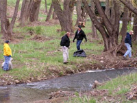 Nancy Schmid, Delbert Stover, Ken Edel, and Lee Jensen work on Rapid Creek clean-up.