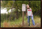 Mike Johnson installing the sign at the dock at Waggoner Lake.