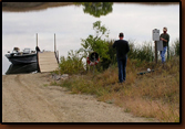 Looking down the boat ramp at Waggoner Lake. Mike Johnson is hanging the sign at right while visiting with a passing angler prior to his outing.