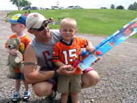 A happy young fisherman with the new pole he won at the Party at the Lake at EAFB. Combo donated by RCAC.